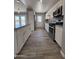 Well-designed kitchen with modern appliances, white cabinets, gray countertops, and wood-look tile flooring at 5815 N 21St Ave, Phoenix, AZ 85015