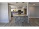 Updated kitchen featuring white cabinets, granite countertops, stainless steel appliances, and a stylish tile backsplash at 5815 N 21St Ave, Phoenix, AZ 85015