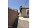 Gated side yard with gravel and concrete walkway, leading to back entrance at 5815 N 21St Ave, Phoenix, AZ 85015
