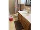 Cozy bathroom featuring a single sink vanity and a shower with a floral curtain at 5833 W Rosewood Ln, Phoenix, AZ 85031