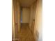 Neutral hallway with doors and tiled flooring at 5833 W Rosewood Ln, Phoenix, AZ 85031