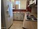 The kitchen features white appliances, a window, and wooden countertops at 5833 W Rosewood Ln, Phoenix, AZ 85031