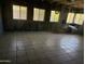 A large room with tiled floors and windows providing natural light at 5833 W Rosewood Ln, Phoenix, AZ 85031