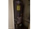 Energy-efficient water heater installed in a utility closet with visible connections and safety labels at 5833 W Rosewood Ln, Phoenix, AZ 85031