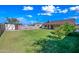 Vast backyard with green lawn, shed, and privacy wall; perfect for outdoor activities at 6160 E Inglewood St, Mesa, AZ 85205