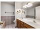 Bright bathroom with a double sink vanity, tiled backsplash, and a separate tub at 6160 E Inglewood St, Mesa, AZ 85205