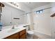 Full bathroom featuring a large mirror, oak cabinets, and combination tub and shower at 6160 E Inglewood St, Mesa, AZ 85205