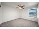Bright bedroom with a window offering natural light and neutral-toned carpeting at 6160 E Inglewood St, Mesa, AZ 85205