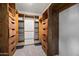 Walk-in closet with custom wood shelving and drawers at 6160 E Inglewood St, Mesa, AZ 85205