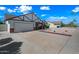 Spacious driveway leading to a two-car garage, complemented by desert-style landscaping at 6160 E Inglewood St, Mesa, AZ 85205