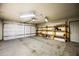 Spacious garage with shelves and a garage door at 6160 E Inglewood St, Mesa, AZ 85205