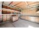 Finished garage interior with built-in storage cabinets and shelving for organization at 6160 E Inglewood St, Mesa, AZ 85205