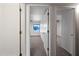 Hallway view of carpeted rooms with ceiling fans and natural light at 6160 E Inglewood St, Mesa, AZ 85205
