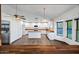 Bright kitchen featuring white cabinets, wood countertops, and eat-in island at 6160 E Inglewood St, Mesa, AZ 85205