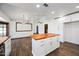 Kitchen with a white island and wood countertops leading to a dining area at 6160 E Inglewood St, Mesa, AZ 85205