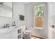 Bright bathroom with modern vanity, white fixtures, and a window with natural light at 630 E Jensen St # 102, Mesa, AZ 85203