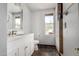 Bright bathroom featuring modern vanity with ample lighting, enhanced by natural light from the window at 630 E Jensen St # 102, Mesa, AZ 85203