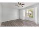 Bedroom featuring wood-look flooring, ample natural light, and a ceiling fan for comfortable living at 630 E Jensen St # 102, Mesa, AZ 85203