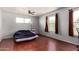 Spacious bedroom with wood flooring, ceiling fan, and dual windows offering natural light at 630 E Jensen St # 102, Mesa, AZ 85203