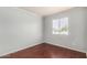 Empty bedroom with hardwood floors, a window providing natural light, and neutral-toned walls at 630 E Jensen St # 102, Mesa, AZ 85203