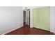 Empty bedroom featuring hardwood floors and ample closet space with sliding doors at 630 E Jensen St # 102, Mesa, AZ 85203