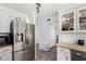 Modern kitchen with stainless steel appliances, light gray cabinets, and gray wood flooring at 630 E Jensen St # 102, Mesa, AZ 85203