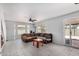 Spacious living room with neutral tile flooring, a ceiling fan, and natural light at 630 E Jensen St # 102, Mesa, AZ 85203