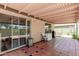 Outdoor patio space featuring tile flooring, covered roof and backyard access through glass sliding doors at 630 E Jensen St # 102, Mesa, AZ 85203