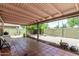 Covered outdoor patio space features tile flooring and backyard access with beautiful desert landscaping at 630 E Jensen St # 102, Mesa, AZ 85203