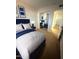 Stylish bedroom with a blue bed frame, white linens, and mirrored closet doors at 720 S Dobson Rd # 95, Mesa, AZ 85202