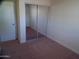 Neutral bedroom with carpet flooring and closet with mirrored sliding doors at 720 S Dobson Rd # 95, Mesa, AZ 85202