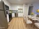 Well-lit kitchen with stainless steel appliances, white cabinets, and a dining area at 720 S Dobson Rd # 95, Mesa, AZ 85202