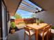 Relaxing patio featuring a wooden table and chairs, ideal for enjoying outdoor meals and gatherings at 720 S Dobson Rd # 95, Mesa, AZ 85202