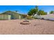 Spacious backyard with rock landscaping, gravel, and an inviting fire pit area at 810 W Villa Maria Dr, Phoenix, AZ 85023