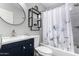 Bathroom featuring a new vanity, updated lighting and fixtures, and a shower-tub combination at 810 W Villa Maria Dr, Phoenix, AZ 85023