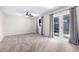 Spacious carpeted bedroom with ceiling fan, two windows, and a door to the backyard at 810 W Villa Maria Dr, Phoenix, AZ 85023