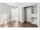 Bedroom with wood-look floors, open closet, and neutral color palette at 810 W Villa Maria Dr, Phoenix, AZ 85023