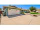 Spacious driveway leading to a two-car garage, complemented by rock garden and artificial grass at 810 W Villa Maria Dr, Phoenix, AZ 85023