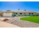Charming single-story home with verdant lawn, rock garden, and well-maintained landscaping at 810 W Villa Maria Dr, Phoenix, AZ 85023