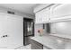 Eat-in kitchen includes white cabinets, stainless appliances, granite counters, and white tiled floor at 810 W Villa Maria Dr, Phoenix, AZ 85023