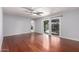 Bright living room featuring hardwood floors, ceiling fan, and sliding glass doors to the backyard at 810 W Villa Maria Dr, Phoenix, AZ 85023