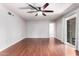 Inviting living room with hardwood floors, ceiling fan, and sliding glass door at 810 W Villa Maria Dr, Phoenix, AZ 85023
