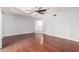 Open-concept living area with hardwood floors, light gray walls, and a ceiling fan at 810 W Villa Maria Dr, Phoenix, AZ 85023