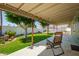 Inviting covered patio with an outdoor seating area overlooking the lush backyard at 810 W Villa Maria Dr, Phoenix, AZ 85023