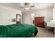 Spacious bedroom with neutral carpet, ceiling fan and large dresser at 829 S 111Th Dr, Avondale, AZ 85323