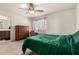 Bedroom featuring a ceiling fan, neutral carpet, and a desk area with natural light at 829 S 111Th Dr, Avondale, AZ 85323