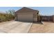 Exterior shot of a one story single Gathering home with a two car garage and desert landscaping at 829 S 111Th Dr, Avondale, AZ 85323