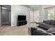 The living room offers a neutral color palette, carpeted floor, a gray sofa, and a front door at 829 S 111Th Dr, Avondale, AZ 85323