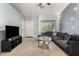 The living room has gray walls, carpeted floors, a comfy sectional sofa, and a front door at 829 S 111Th Dr, Avondale, AZ 85323