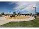 Community playground featuring modern play equipment, benches, and mature trees providing shade for families to enjoy at 848 W Riparian Dr, San Tan Valley, AZ 85140